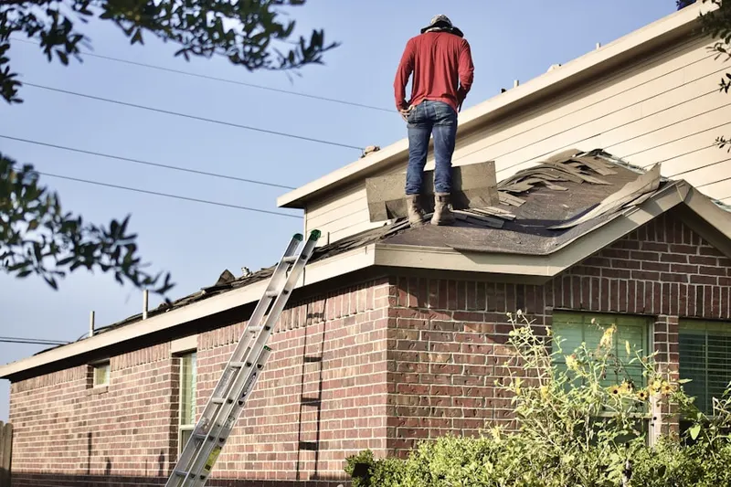 Professional roofer working on a residential roof in Woodlyn